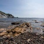 Rocks and water on the shore of a beach. Weekend Getaway on Cape Breton Island